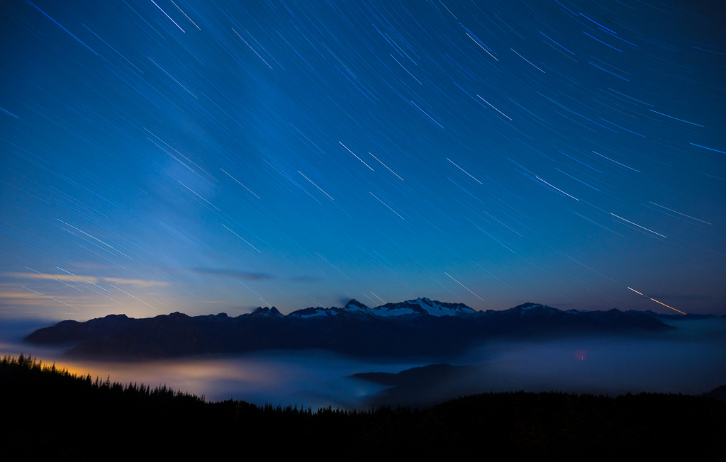 Faint outline of Milky Way over the Tantalus Range, with cloud filled Squamish Valley, BC.